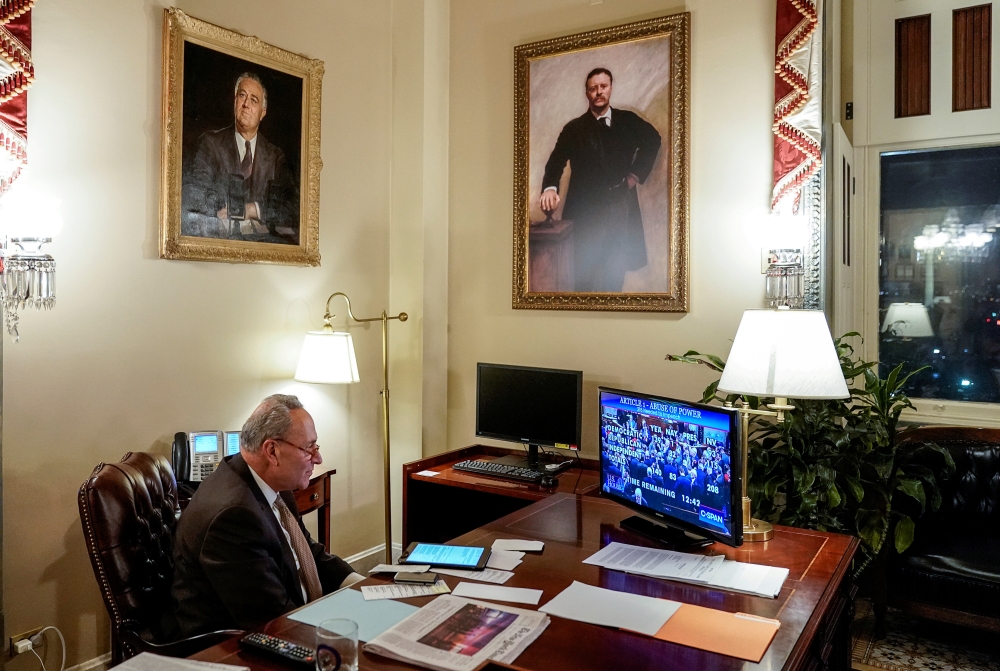 Senate Democratic Leader Chuck Schumer (D-NY) watches the vote count in his Capitol Hill office as the US House of Representatives votes on the first of two articles of impeachment against US President Donald Trump in Washington, December 18, 2019. Reuter