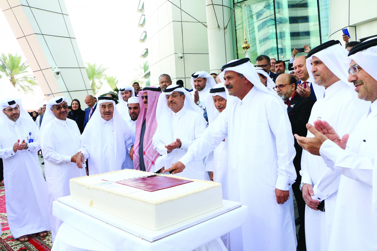 Sheikh Fahd bin Mohammed bin Jabr Al Thani, Chairman of the Board of Directors of Doha Bank, cutting a cake to mark opening of the celebrations.