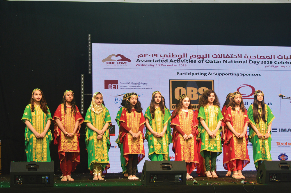 Students of Pakistan International School-Qatar performing at Lusail Multipurpose Hall during Qatar National Day celebrations. 