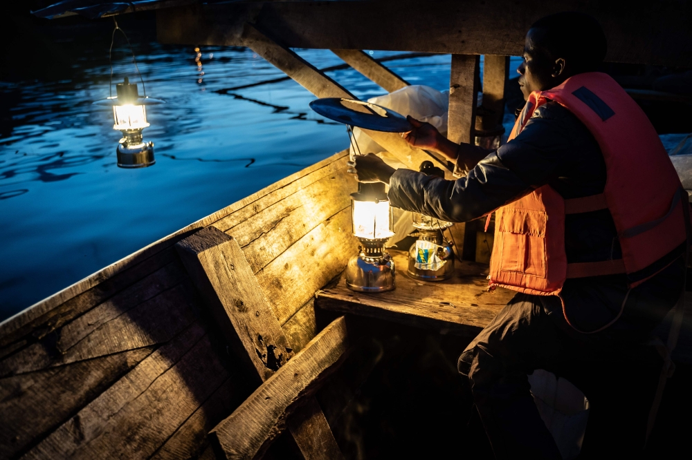 Representative image: A fisherman prepares lanterns to attract sardines after sunset for their overnight fishing at Lake Kivu, Kibuye, western Rwanda, on November 18, 2019. AFP / Simon Wohlfahrt 