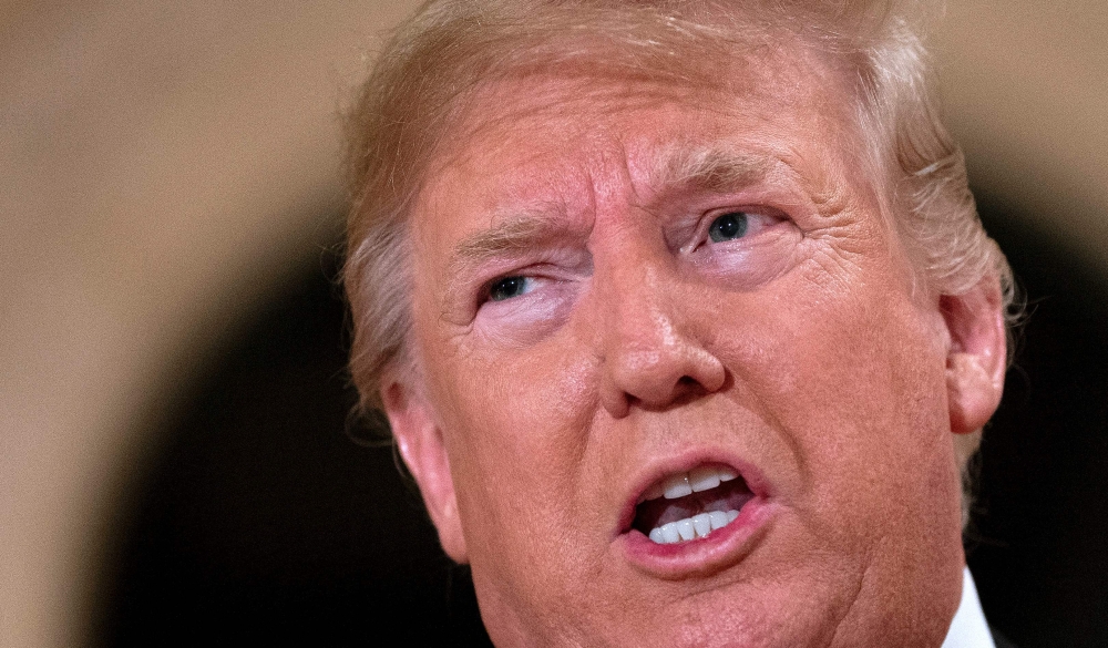 US President Donald Trump speaks to the press outside the grand ballroom as he arrives for a New Year's celebration at Mar-a-Lago in Palm Beach, Florida on December 31, 2019. AFP / Jim Watson