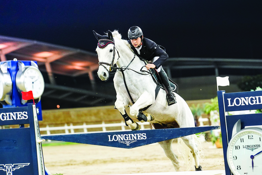 Kamil Sabitov guiding Quintendro over an obstacle during the Medium Tour competition of the Fifth Round of Longines hathab Equestrian Tour, yesterday.