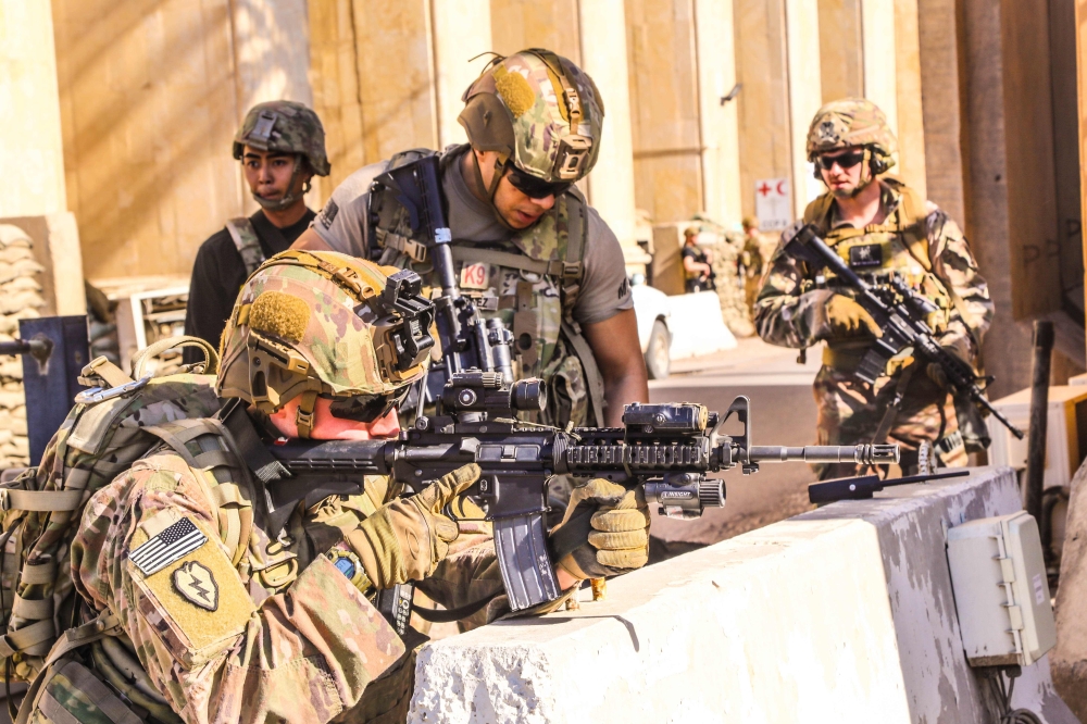 A handout picture received from the US embassy in Iraq on December 31, 2019, shows American soldiers taking position around the embassy in the capital Baghdad, after supporters and members of the Hashed al-Shaabi military network breached the outer wall o