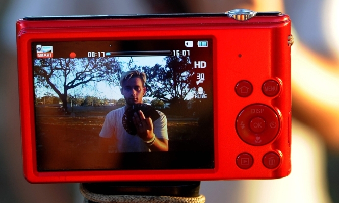 A Cuban youtuber records a magicians performance for her YouTube channel in Havana on February 26, 2018. AFP / Yamil Lage
