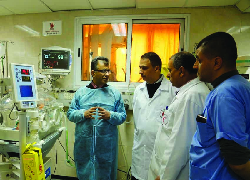 Healthcare professionals during a discussion at a hospital in Palestine.