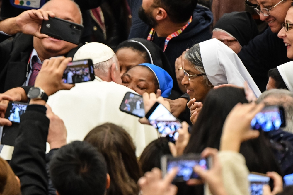 Pope Francis kisses a nun who had been shouting 