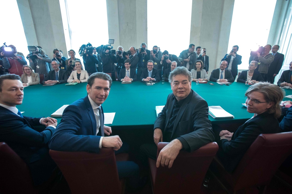 Austrian Chancellor Sebastian Kurz (C-L) and Vice Chancellor Werner Kogler (C-R) have taken seat to attend the first Council of Ministers of Austria's new government coalition of conservatives and Greens in Vienna on January 8, 2020. AFP / Alex Halada
 