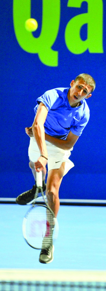 Rashed Nawaf of Qatar serves against Henri Kontinen of Finland and Franco Skugor of Croatia during their Qatar ExxonMobil Open 2020 doubles first round match on Monday.  Pic: Salim Matramkot/The Peninsula