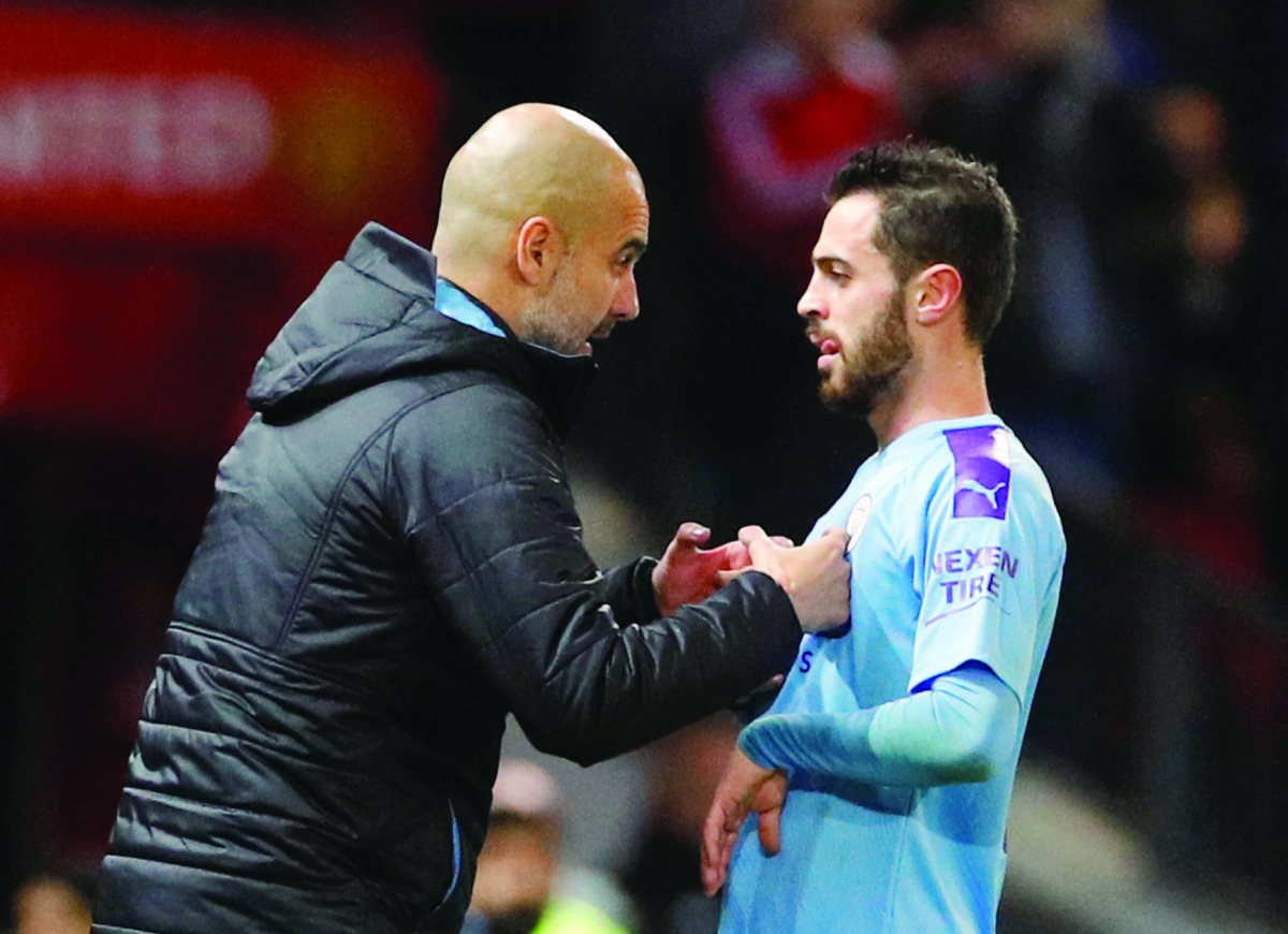 Manchester City manager Pep Guardiola with Bernardo Silva, Carabao Cup, Semi Final First Leg, Manchester United v Manchester City, Old Trafford, Manchester.  January 7, 2020. Reuters/Phil Noble
