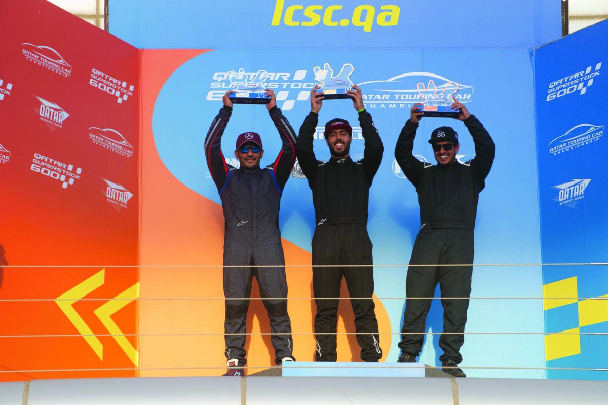 The podium winners at the Qatar Touring Car Championship pose for a picture at the Losail International Circuit