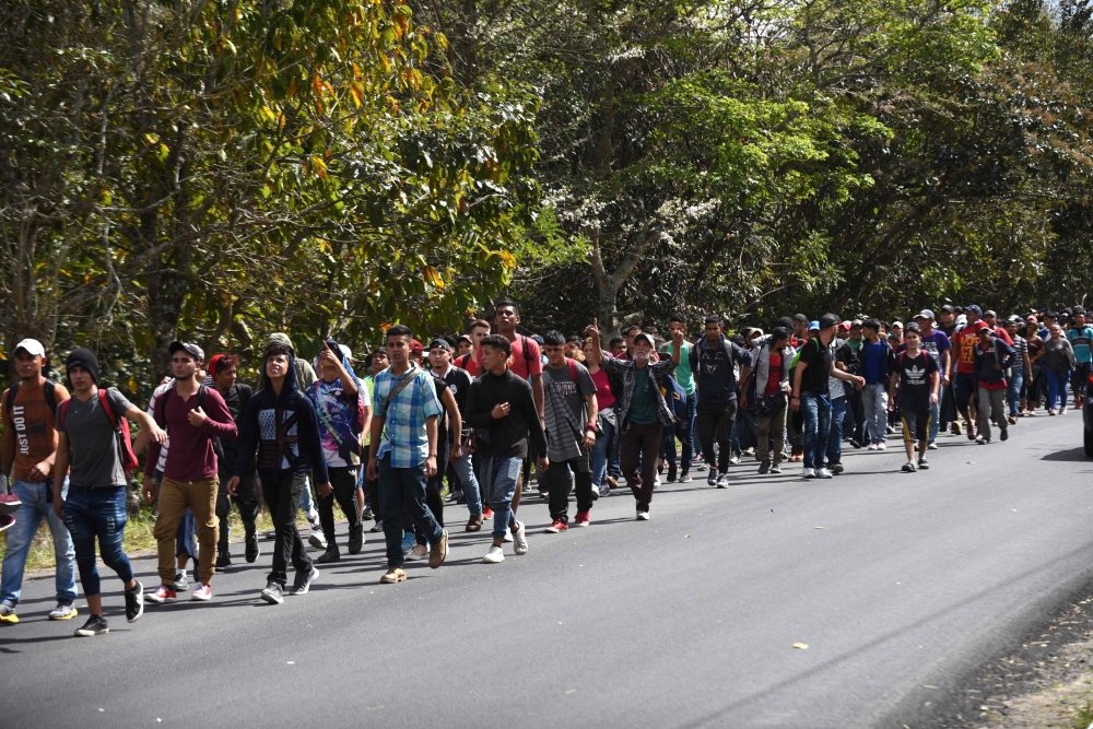 Honduran migrants walk near Esquipulas, Chiquimula departament, Guatemala, on January 16, 2020, after crossing the border in Agua Caliente from Honduras on their way to the US. AFP / Johan Ordonez
 