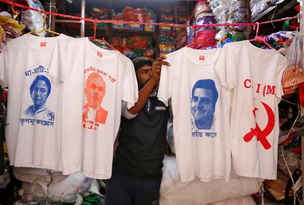 A worker displays T-shirts with images of Mamata Banerjee, Narendra Modi, Rahul Gandhi and logo of CPI-M for sale inside a shop in Kolkata, India, March 26, 2019. Reuters / Rupak De Chowdhuri