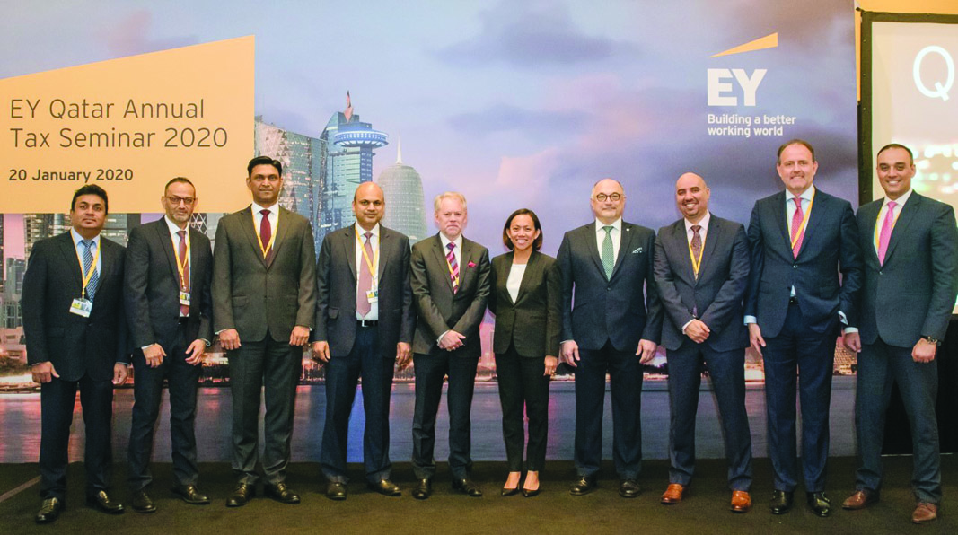 Experts posing for a group picture on the sidelines of  the EY Qatar Annual Tax Seminar.