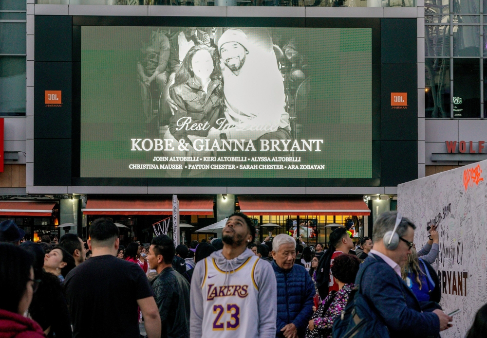 Mourners gather in Microsoft Square near the Staples Center to pay respects to Kobe Bryant after a helicopter crash killed the retired basketball star, in Los Angeles, California, U.S., January 28, 2020. Reuters/Kyle Grillot