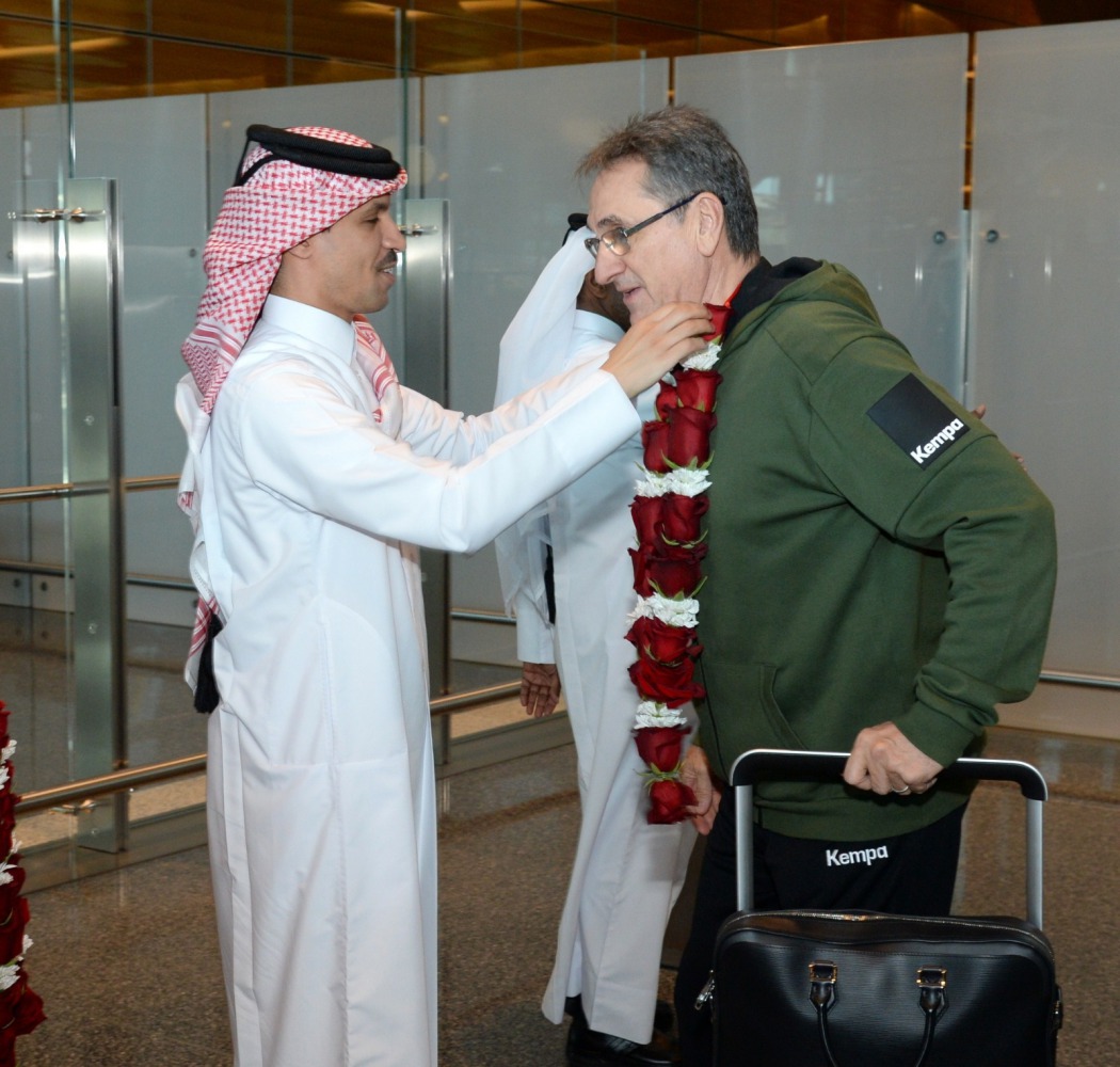 Qatar's victorious coach Valero Rivera greeted upon arrival at Hamad International Airport by Jassim bin Rashid Al Buenain, Secretary General of the Qatar Olympic Committee.