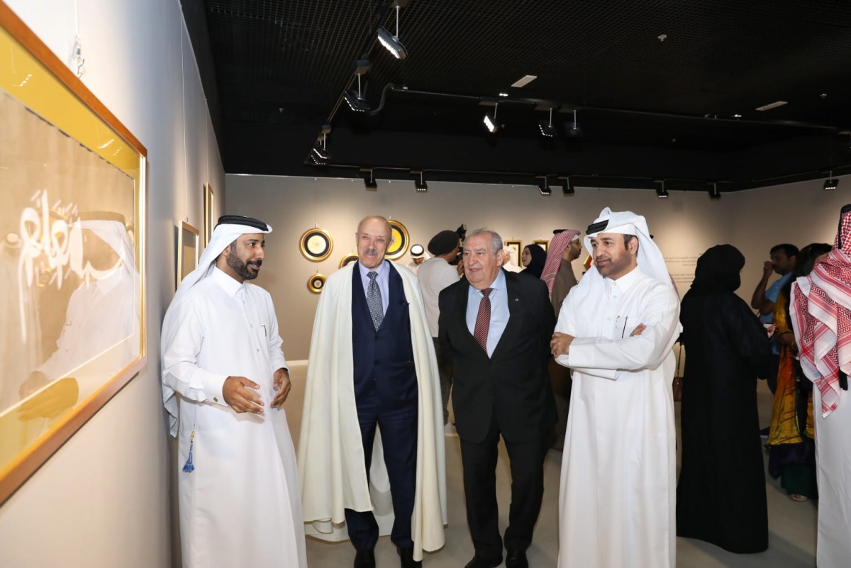 Qatari artist Issa Yousef Al Hassan (left) talks about one of his works to Dr. Khalid bin Ibrahim Al Sulaiti, General Manager of Katara (right) and other guests at the launch of “Calligraphy and Illumination” exhibition at Gallery 1 of Katara Building 19,