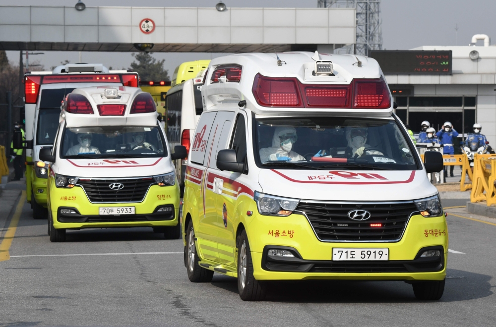Ambulances carrying South Korean citizens repatriated from the Chinese city of Wuhan leave Gimpo airport in Seoul on January 31, 2020, following the arrival of the first charter flight arranged by South Korean government to evacuate its citizens from the 