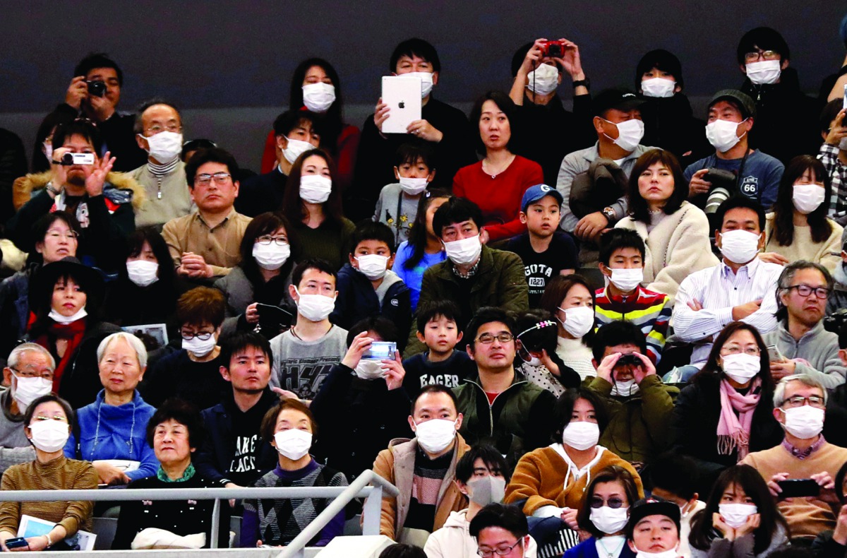 Visitors wearing surgical masks attend the opening ceremony of the Ariake Arena, which will host volleyball and wheelchair basketball competitions in Tokyo 2020 Olympic Games in Tokyo, Japan, yesterday.
