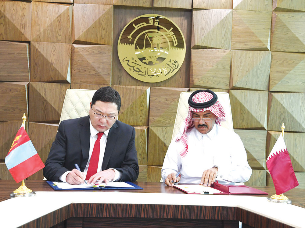Secretary General of the Ministry of Foreign Affairs of Qatar, H E Dr. Ahmed bin Hassan Al Hammadi (right), and the State Secretary of the Ministry of Foreign Affairs of Mongolia, H E Davaasuren Damdinsuren. signing a memorandum of understanding (MoU) to 