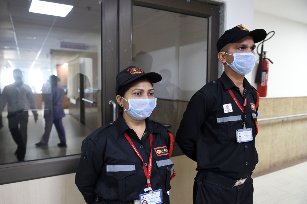 Security guards wearing protective facemasks keep vigil outside an isolation ward opened as a preventative measure following a SARS-like virus outbreak, at the Sardar Vallabhbhai Patel Institute of Medical Sciences in Ahmedabad on February 4, 2020. AFP / 