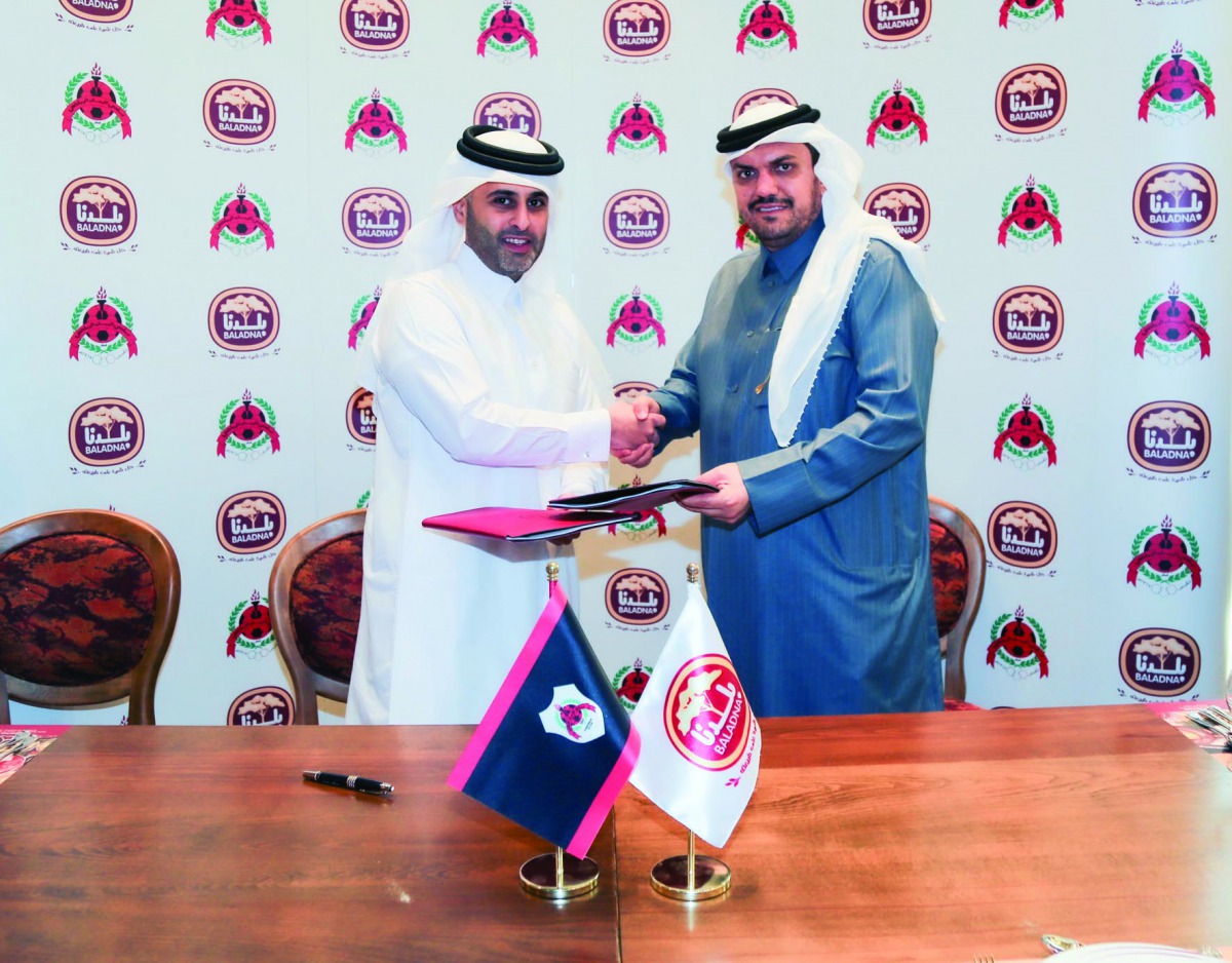 H E Ali bin Saud Al Thani, President of Al Rayyan Sports Club, and Moutaz Al Khayyat, Chairman of Baladna Food Industries, exchanging documents after a sponsorship-signing ceremony yesterday. 
