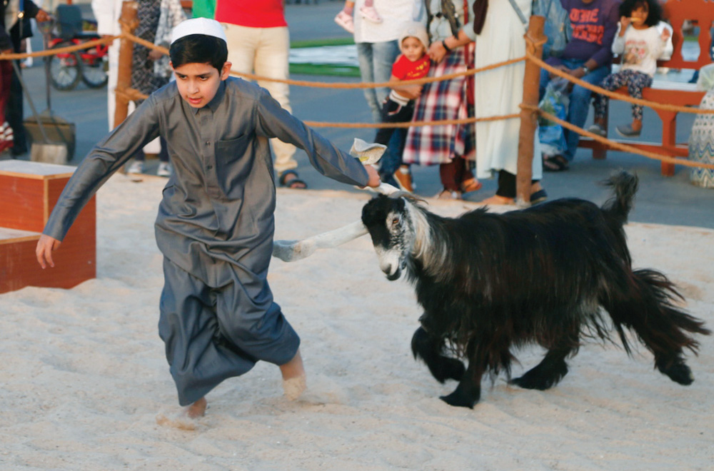 A participant with his goat during the small shepherd competition at the festival. 