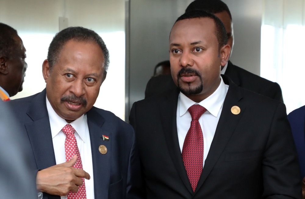 Prime Ministers of Ethiopia and Sudan Abiy Ahmed and Abdalla Hamdok attend the opening session of the 33rd African Union Heads of State Summit in Addis Ababa. M?nasse Wond?mu Ha?lu / Anadolu Agency 
 