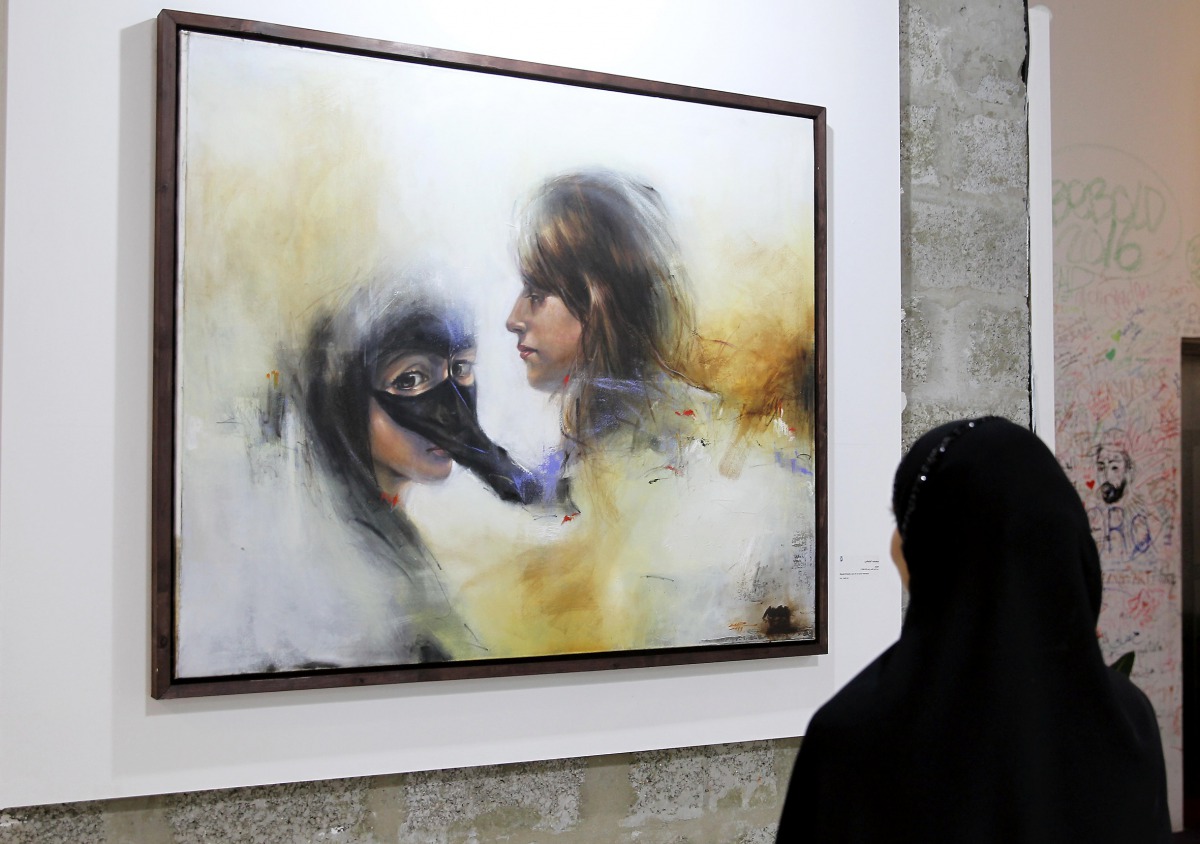 A visitor looks at one of the paintings by Qatari artist Masoud Al Bulushi at W Doha’s Art 29. 