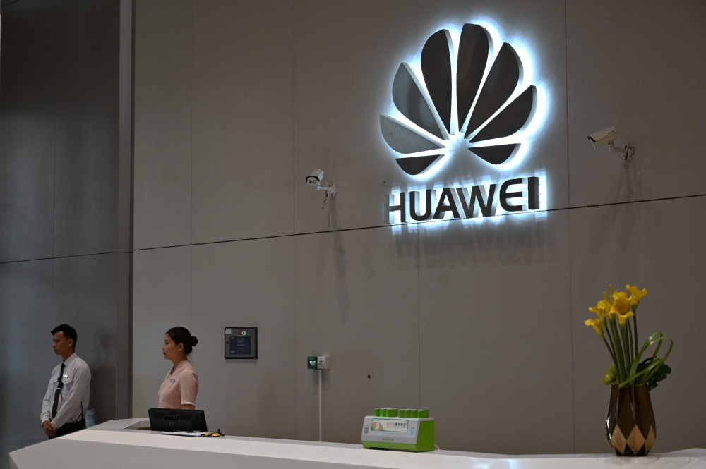 (FILES) In this file photo taken on May 29, 2019, a company logo is displayed at a reception area at the Huawei headquarters in Shenzhen, China's Guangdong province. AFP / Hector Retamal 