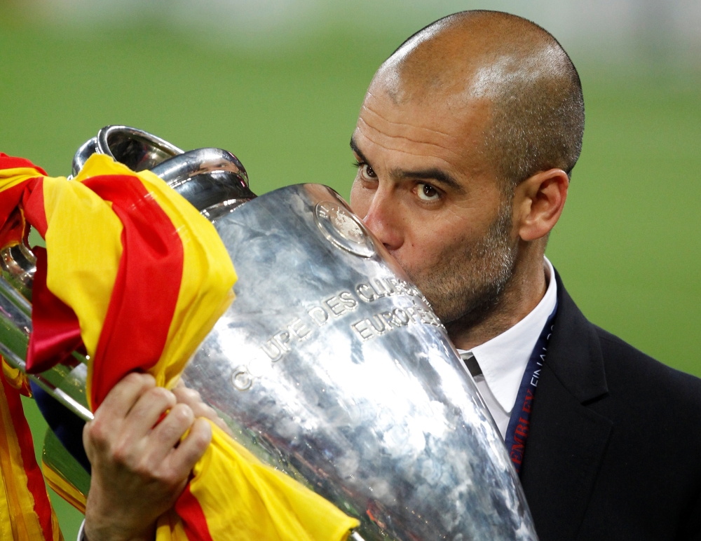 FILE PHOTO: Barcelona's manager Pep Guardiola kisses the trophy after their Champions League final soccer match victory against Manchester United at Wembley Stadium in London May 28, 2011. REUTERS/Phil Noble