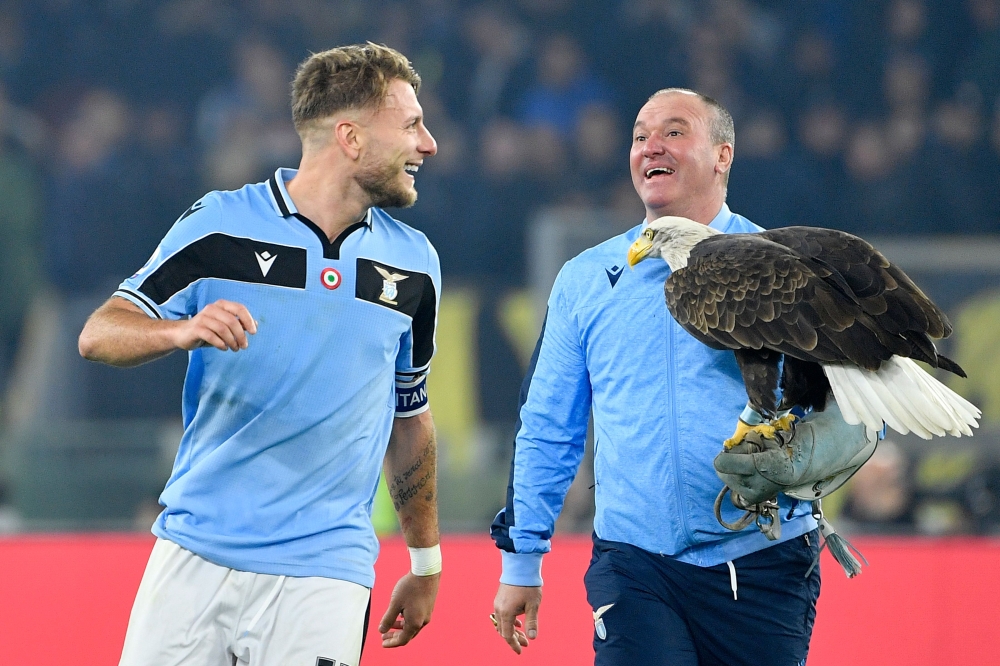 Lazio's Italian forward Ciro Immobile (L) reacts next to the club's mascot eagle at the end of the Italian Serie A football match Lazio Rome vs Inter Milan on February 16, 2020 at the Olympic stadium in Rome. / AFP / Filippo MONTEFORTE