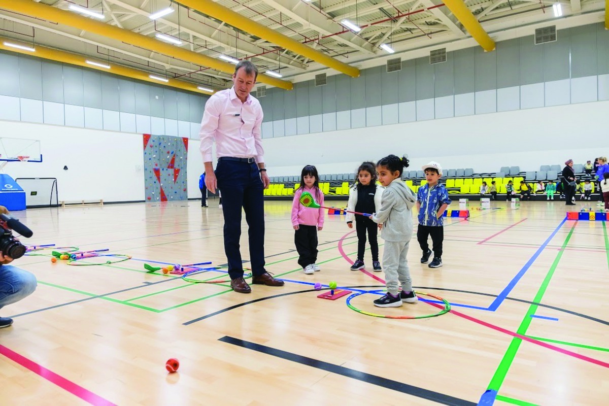 Young kids receive golf tips from an instructor at the Education City Golf Club. 