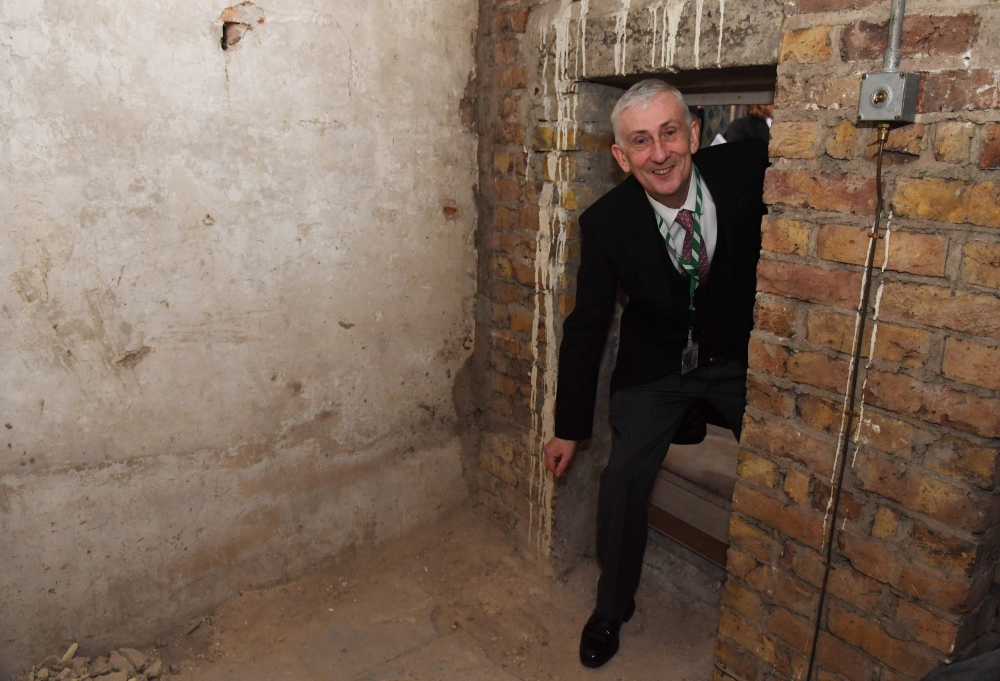 A handout photograph released by the UK Parliament on February 26, 2020, shows Speaker of the House of Commons Lindsay Hoyle visiting secret chamber concealing a 360-year-old blocked passageway rediscovered during renovation work in the Houses of Parliame
