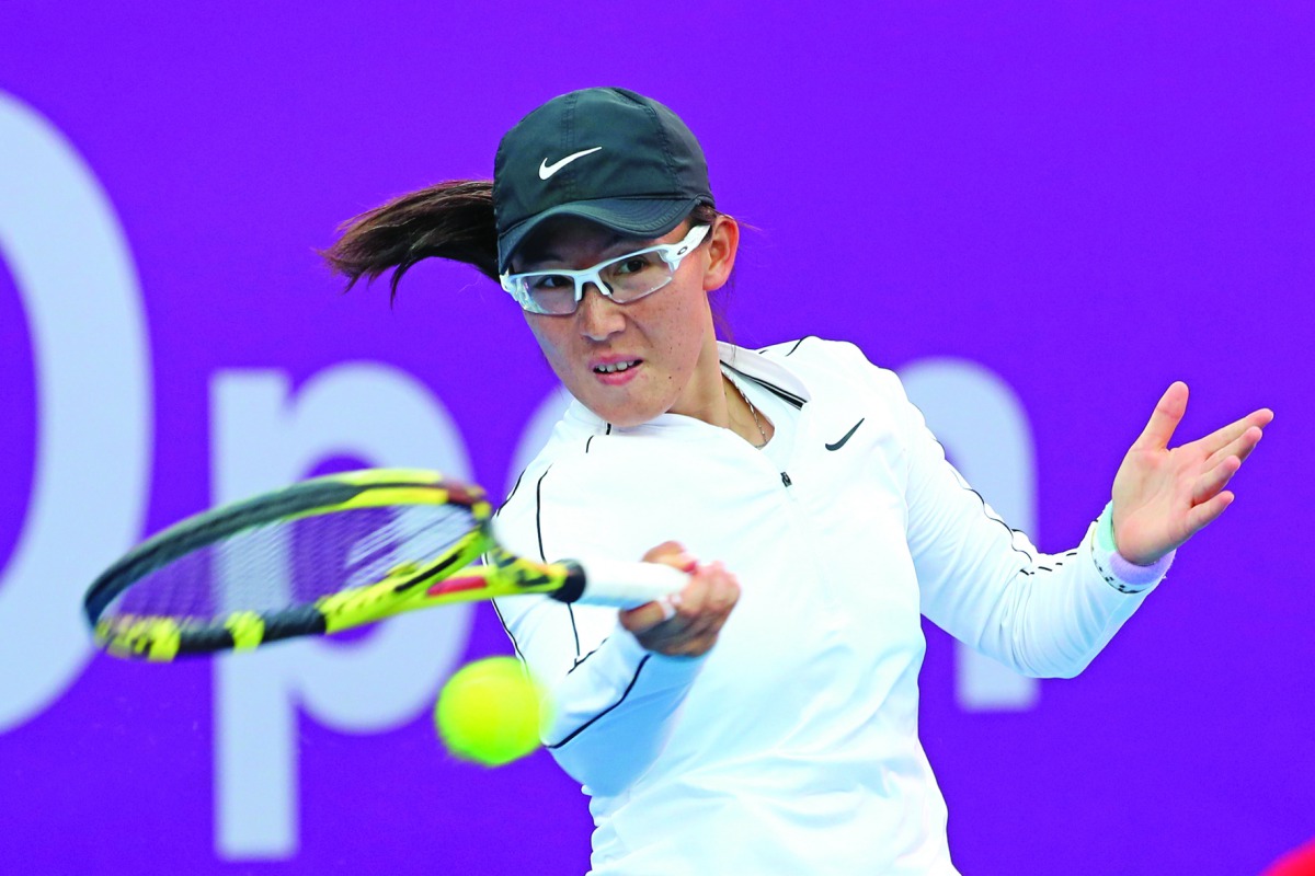 Zheng Saisai of China returns the ball to Aryna Sabalenka of Belarus during the Qatar Total Open on Thursday.