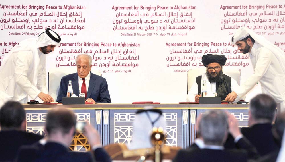 US Special Representative for Afghanistan Reconciliation, Zalmay Khalilzad (left), and Head of Afghan Taliban’s Political Office, Mullah Abdul Ghani Baradar, during the signing of the peace deal, at the Sheraton Doha Hotel yesterday. Baher Amin/The Penins