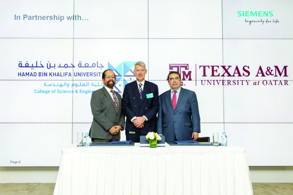 Officials posing for a photo during the announcement of collaboration between Siemens, Texas A&M University and Hamad Bin Khalifa University.