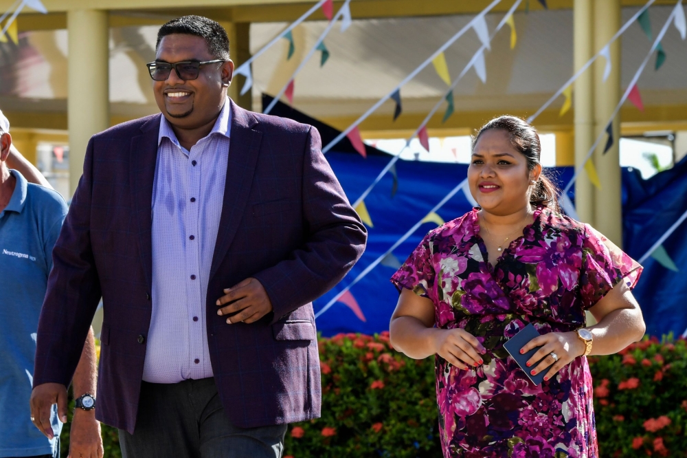 Guyana's presidential candidate for the opposition leftist People's Progressive Party (PPP), Mohamed Irfaan Ali (L), and his wife Arya Ali, are pictured after voting in Leonora, just west of Georgetown, during general elections in Guyana, on March 2, 2020