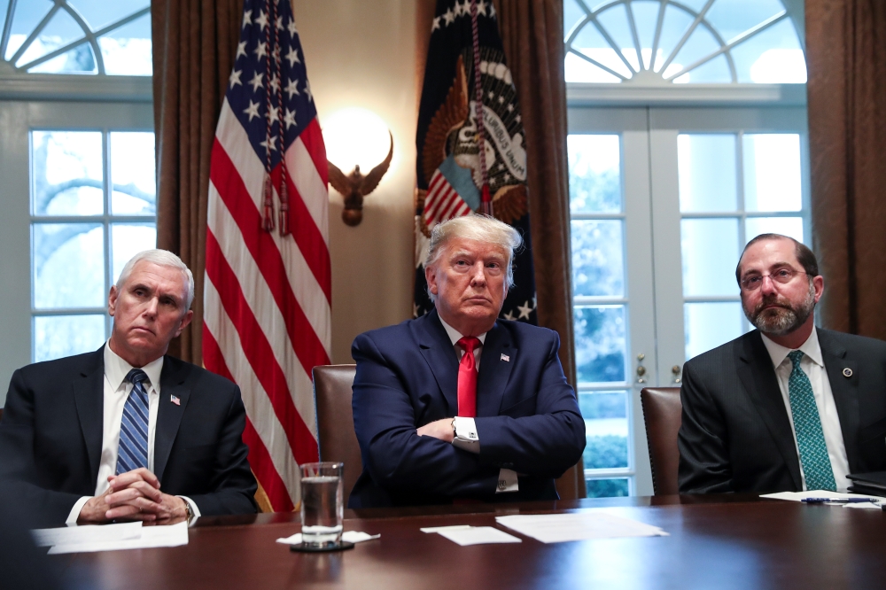 U.S. President Donald Trump is flanked by Vice President Mike Pence and Health and Human Services (HHS) Secretary Alex Azar as Trump hosts a meeting of the coronavirus task force with pharmaceutical executives to discuss developing a coronavirus vaccine, 