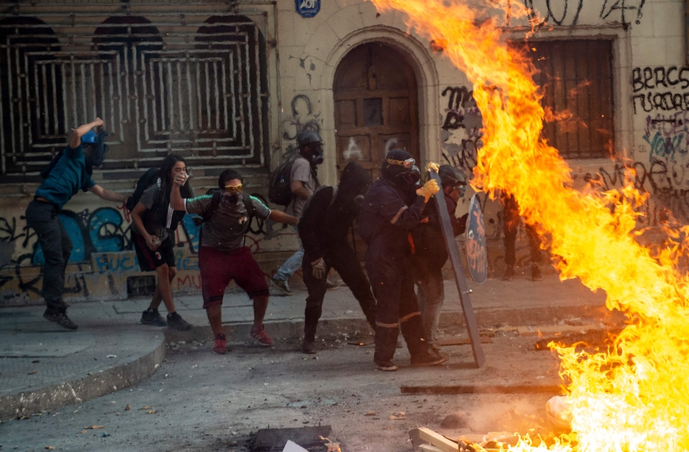 Demonstrators clash with the police during a protest against Chilean President Sebastian Pinera's government in Santiago on March 02, 2020. AFP / Martin Bernetti 
