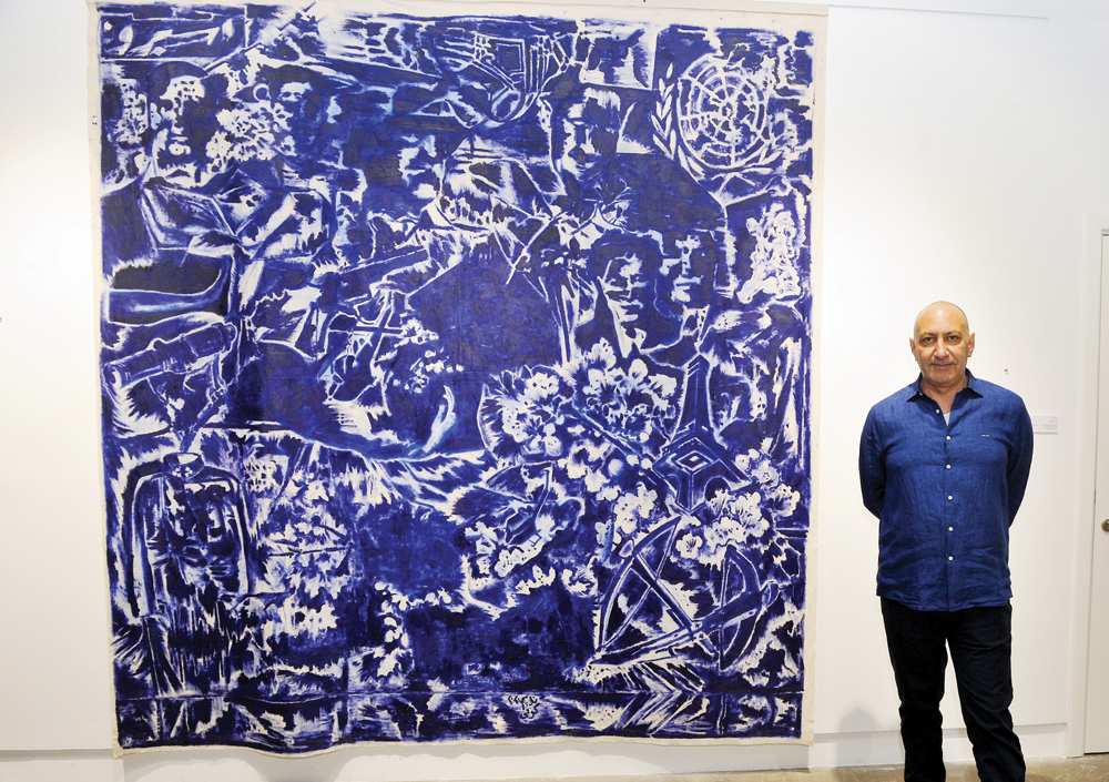 Dutch-Iraqi artist, Nedim Kufi, with one of his works on show at the opening of his solo exhibition titled “Personal Dictionary” at Fire station Workshop 3 yesterday. Pic: Abdul Basit/The Peninsula