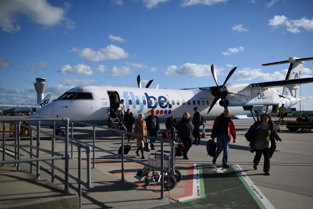 In this file photo taken on November 08, 2017 Passengers dissembark from a flybe aircraft after landing at Jersey Airport in St Peter, north of St Helier, on the British island of Jersey. / AFP / Oli SCARFF
