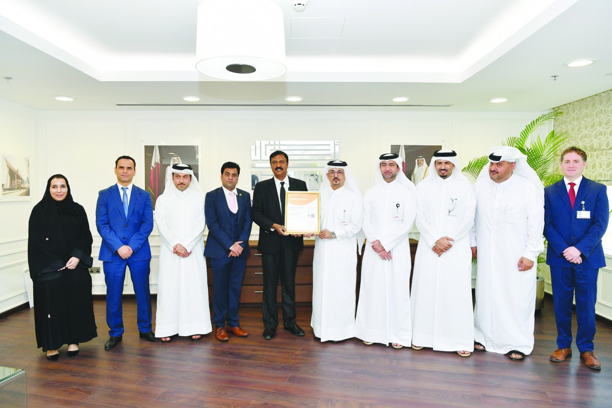 Eng. Jamal Sharida Al Kaabi, Manager of Planning and Quality Department in Ashghal, with other officials receiving the Certificate of Registration of the Quality Management System ISO 9001: 2015 at Ashghal's headquarters.
