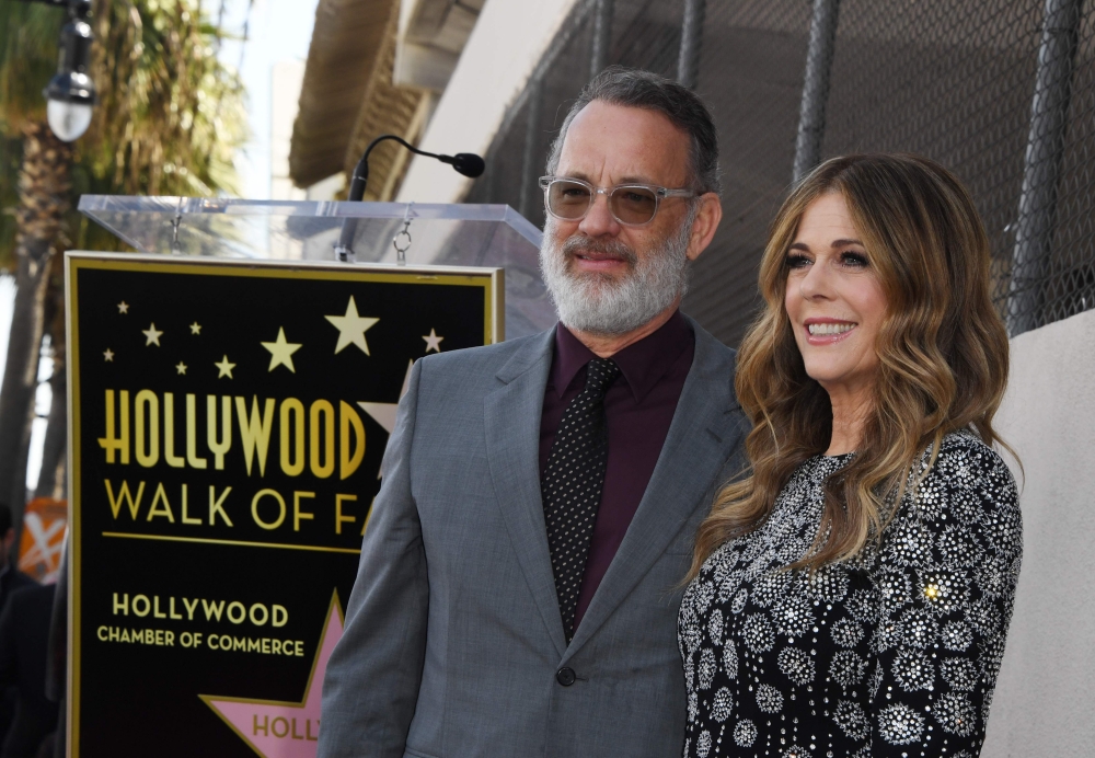 (FILES) In this file photo Tom Hanks and wife Rita Wilson stand before her newly unveiled star after she was honored on the Hollywood Walk of Fame in Hollywood,, California on March 29, 2019.  AFP / Mark RALSTON