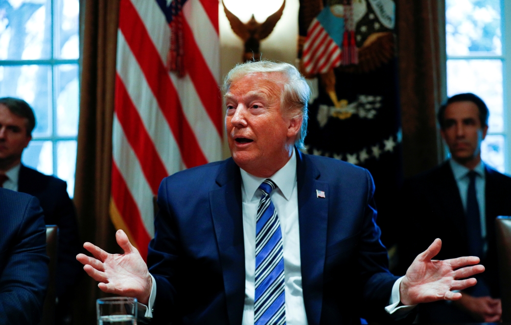FILE PHOTO: U.S. President Donald Trump delivers remarks to the news media during a meeting with bankers on COVID-19 coronavirus response, inside the Cabinet Room at the White House in Washington, U.S., March 11, 2020. REUTERS/Tom Brenner