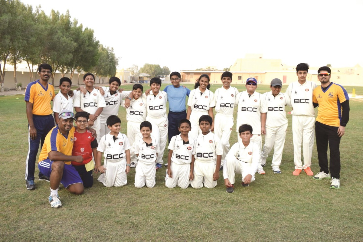 The children of Qatar's Bravo Cricket Academy with coaches during a training session. 