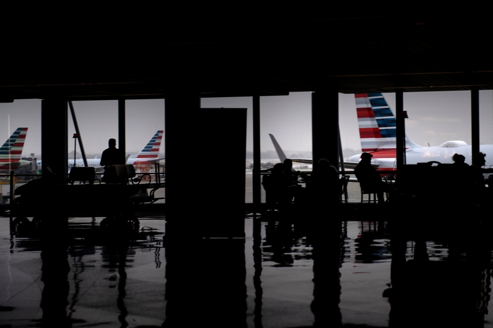 FILE PHOTO: American Airlines planes are seen as passengers wait at O'Hare International Airport in Washington, DC. AFP / Brendan Smialowski