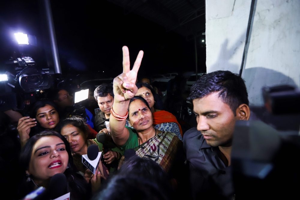 Asha Devi (C), the mother of a gang-rape victim, reacts after the convicts of her daughter's case were hanged in New Delhi on March 20, 2020. India executed four men on March 20 for the gang-rape and murder of a woman on a Delhi bus in 2012 that sparked h
