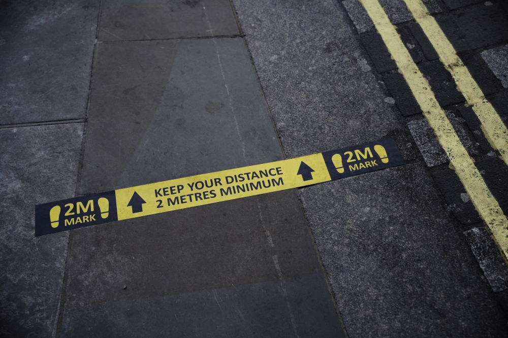 Social distance markings are seen on a street in London, as the spread of the coronavirus disease (COVID-19) continues, London, Britain, April 13, 2020. REUTERS/Hannah McKay