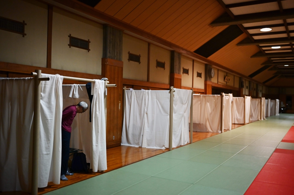 Katsuya Asao, 54, prepares to rest at a shelter provided by Kanagawa prefecture for the people who can’t afford to rent an apartment and used to stay at designated internet cafes, which are closed due to the COVID-19 coronavirus outbreak state of emergenc