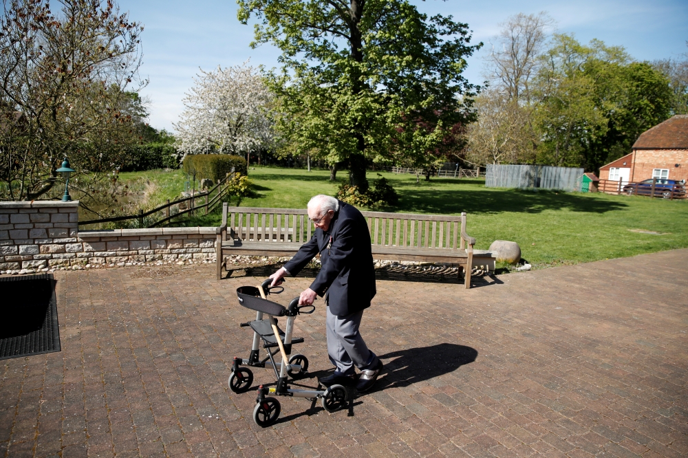 Retired British Army Captain Tom Moore, 99, raises money for health workers by attempting to walk the length of his garden one hundred times before his 100th birthday this month as the spread of coronavirus disease (COVID-19) continues, Marston Moretaine,